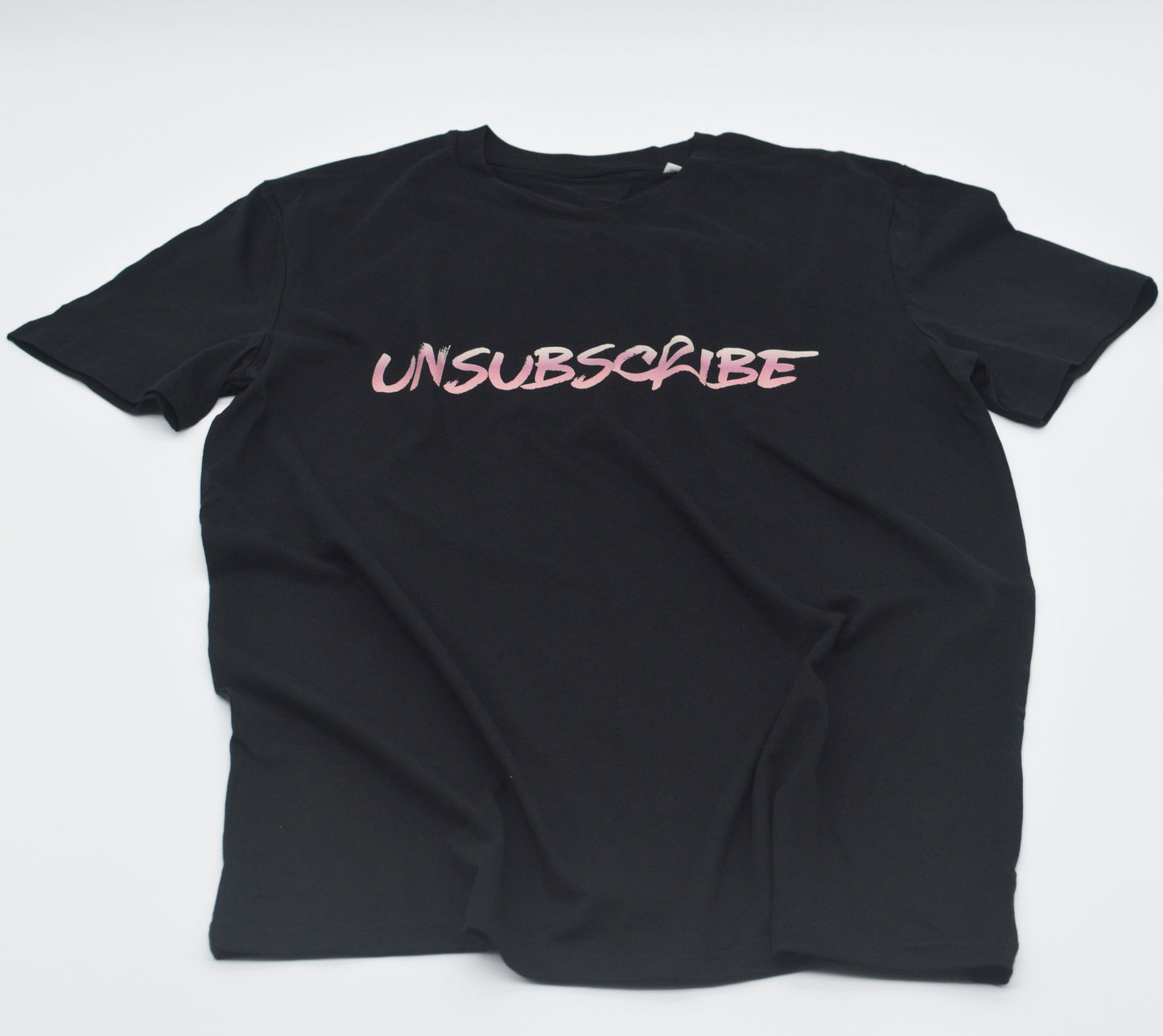 Black t-shirt with 'UNSUBSCRIBE' text in pink on a white background