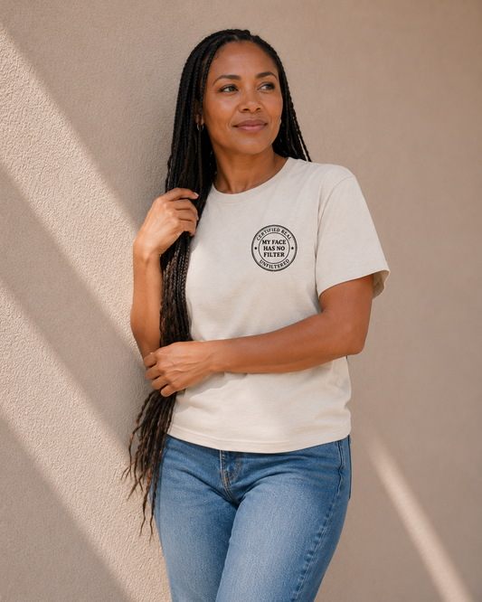 Woman modelling The Bare Minimum Club's vintage white 'My Face Has No Filter' t-shirt, looking off to the side in natural light