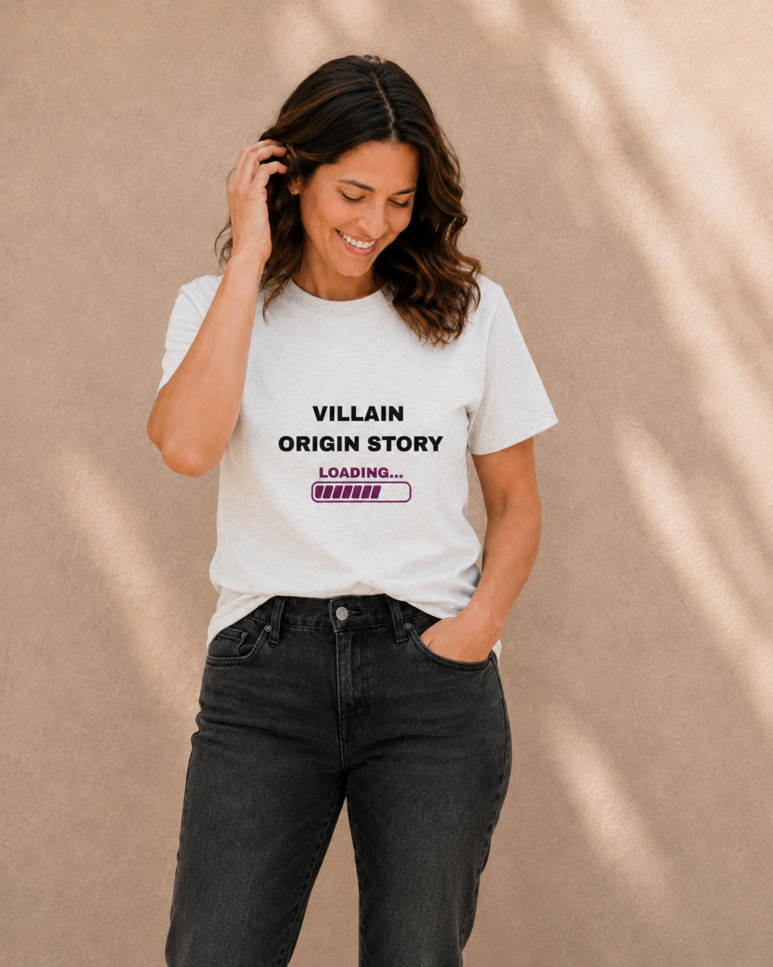 Lifestyle photo of The Bare Minimum Club's white 'Villain Origin Story' graphic t-shirt styled with black jeans