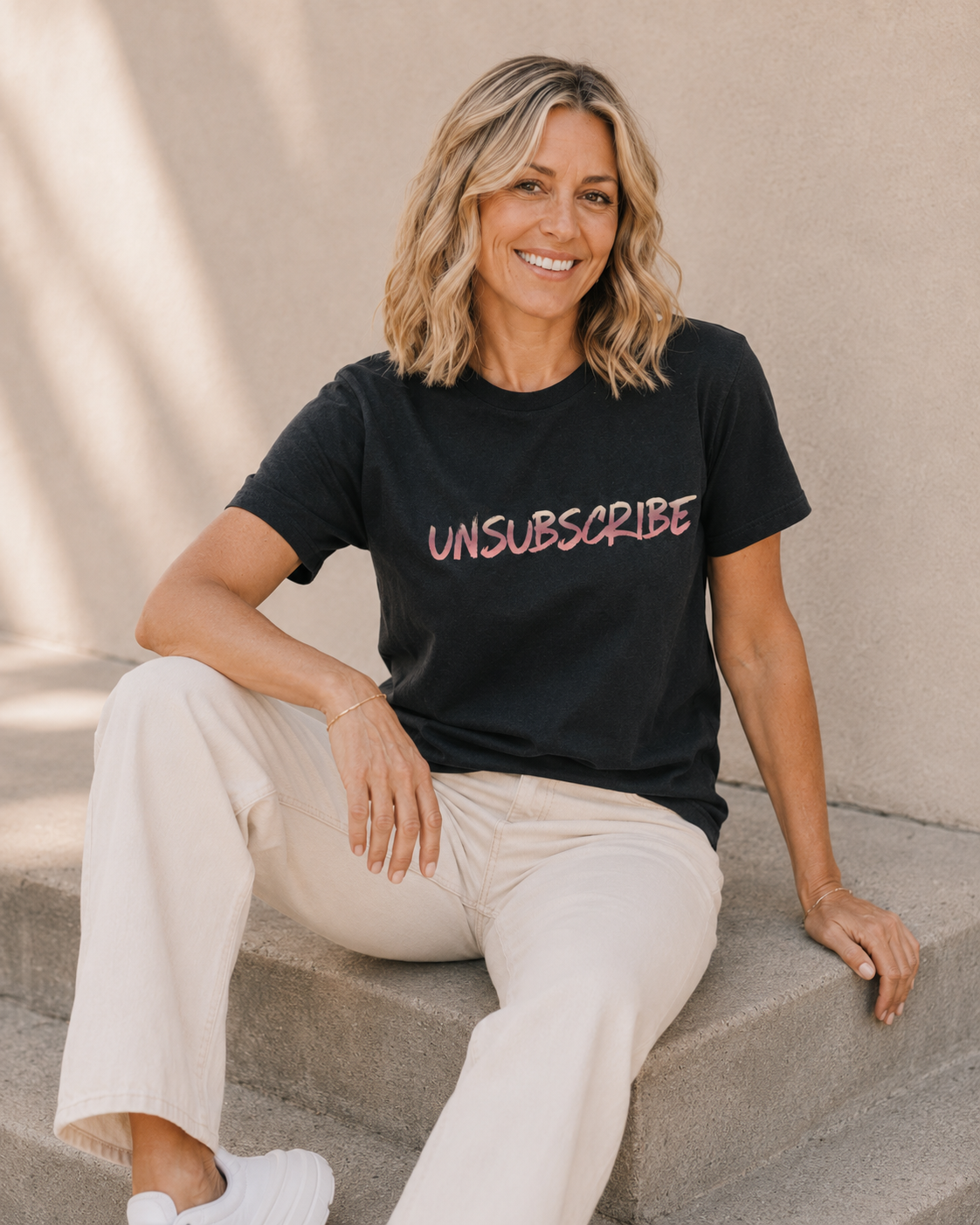 Close-up of woman wearing black 'UNSUBSCRIBE' slogan t-shirt