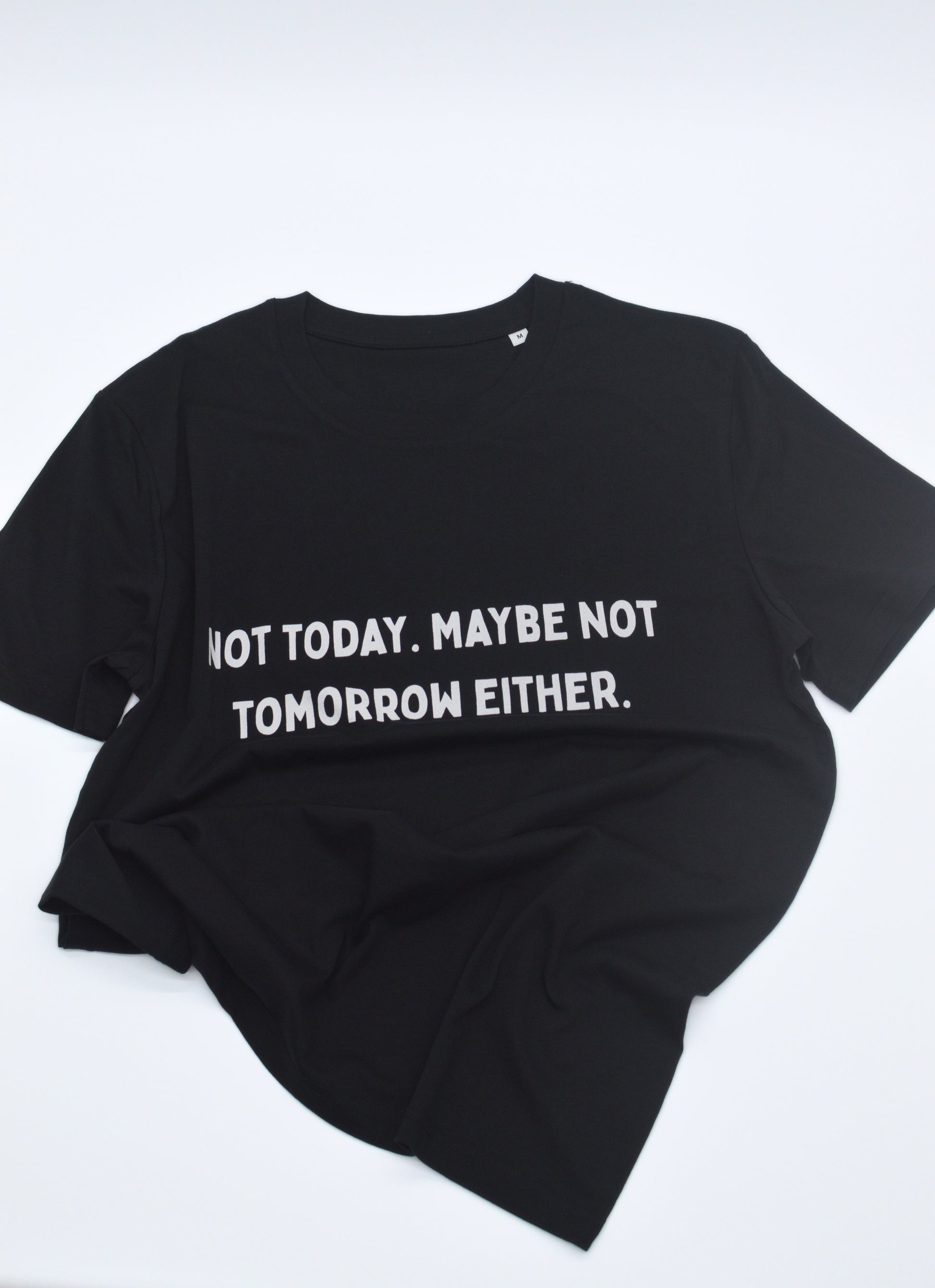 Black t-shirt with white text 'NOT TODAY. MAYBE NOT TOMORROW EITHER' on a white background