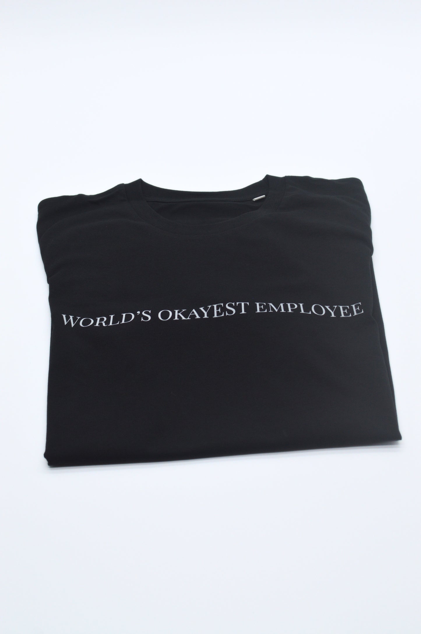 Black t-shirt with 'World's Okayest Employee' text on a white background