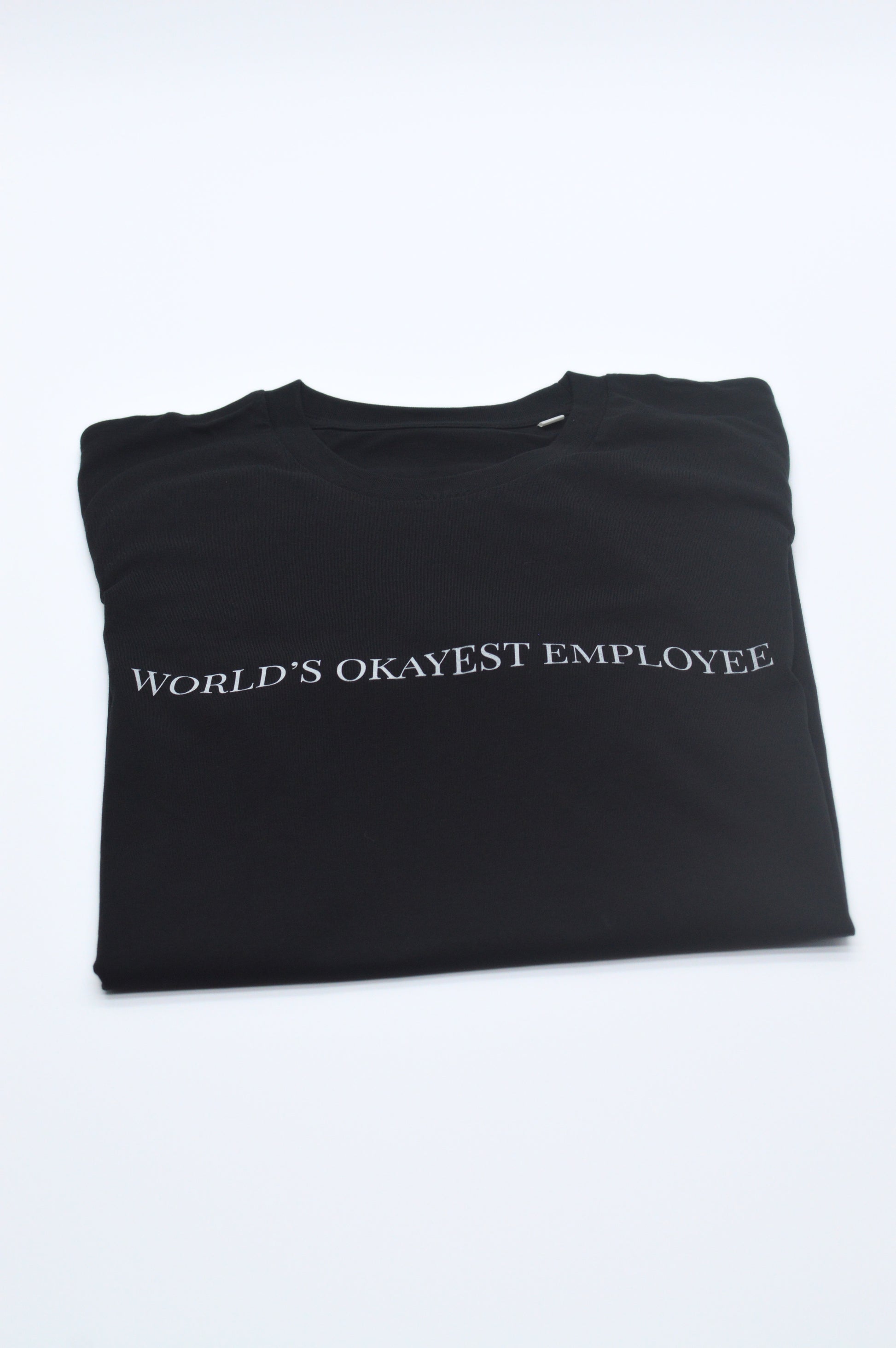 Black t-shirt with 'World's Okayest Employee' text on a white background