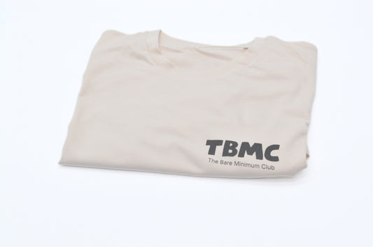 Folded vintage white t-shirt with 'TBMC' logo on a white background