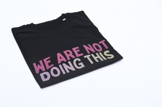 Black t-shirt with colorful text 'WE ARE NOT DOING THIS' on a white background