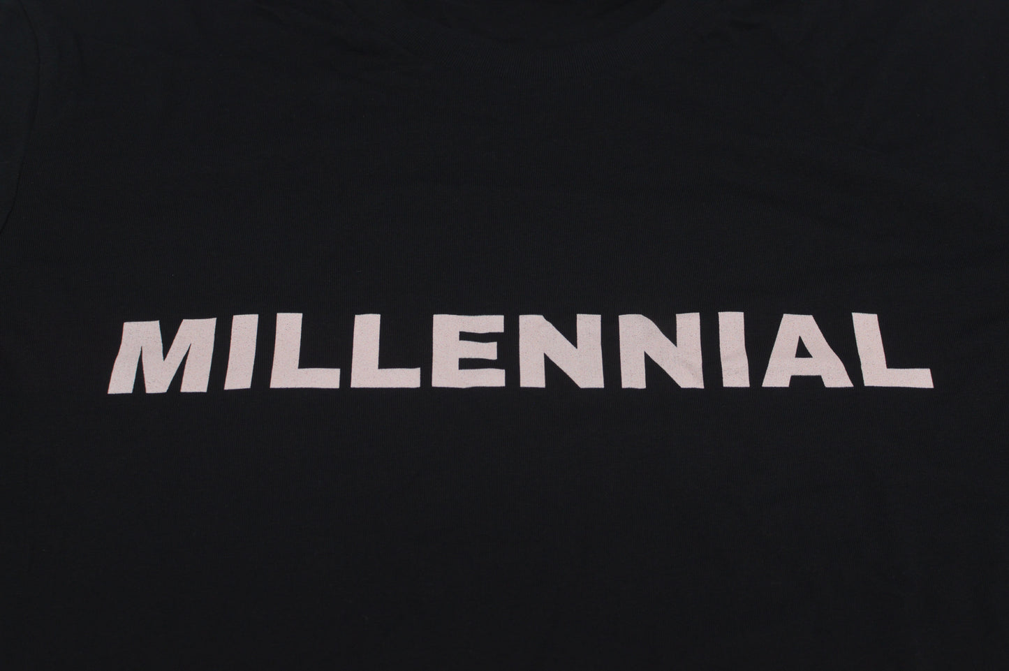 Black t-shirt with 'MILLENNIAL' text on a white background