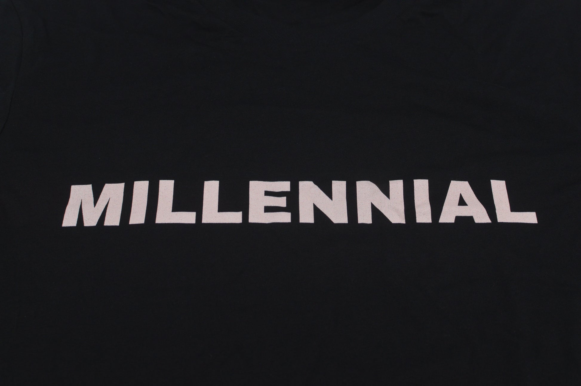 Black t-shirt with 'MILLENNIAL' text on a white background
