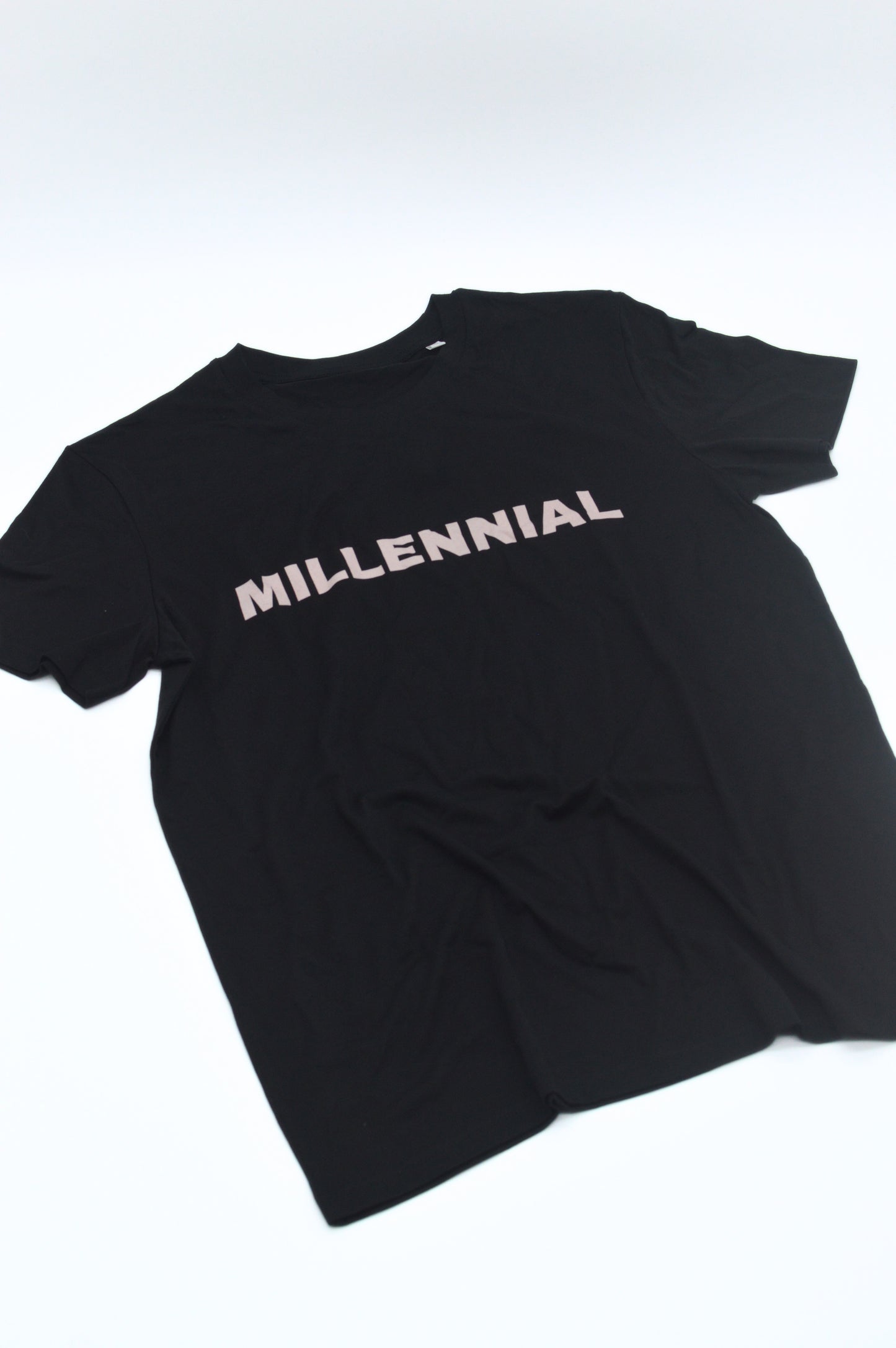 Black t-shirt with 'MILLENNIAL' text on a white background