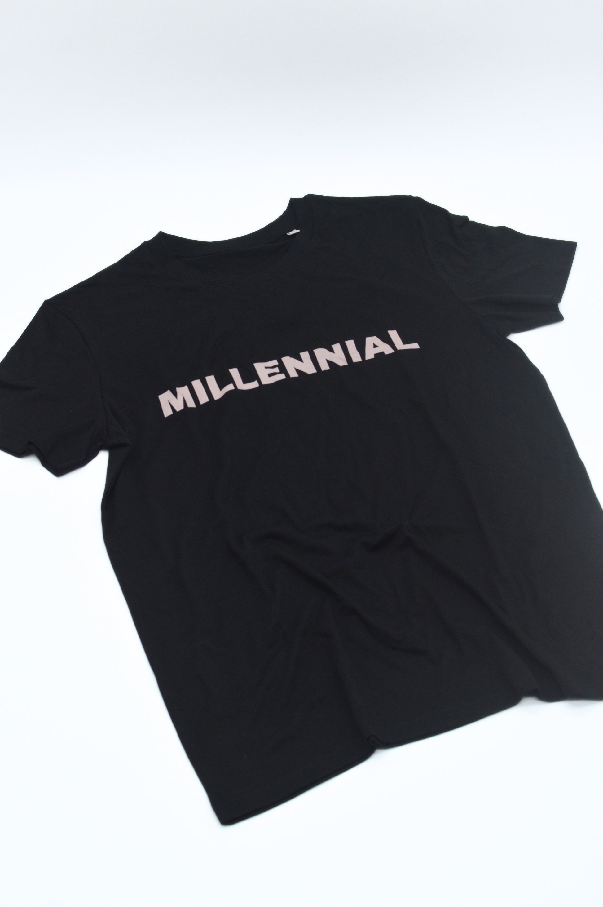 Black t-shirt with 'MILLENNIAL' text on a white background