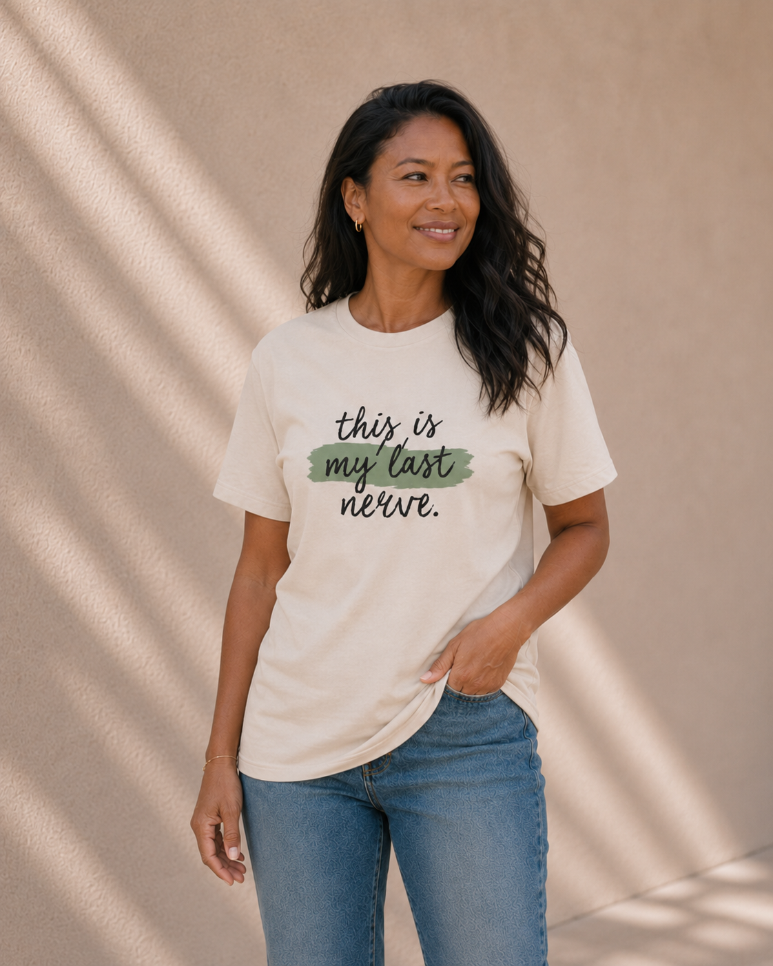 Woman modelling The Bare Minimum Club's vintage white 'This Is My Last Nerve' t-shirt, smiling in natural light